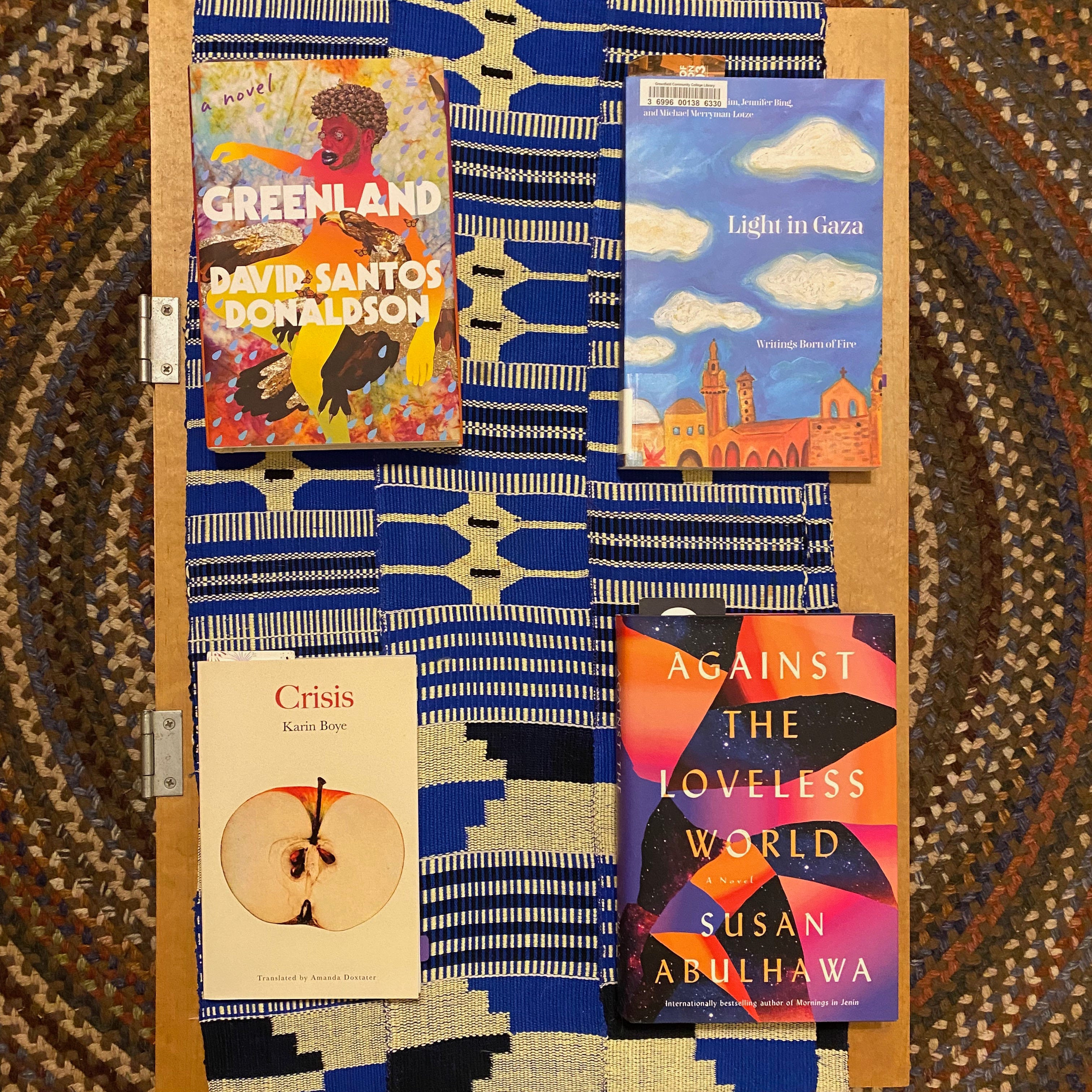 The four listed books on a coffee table.